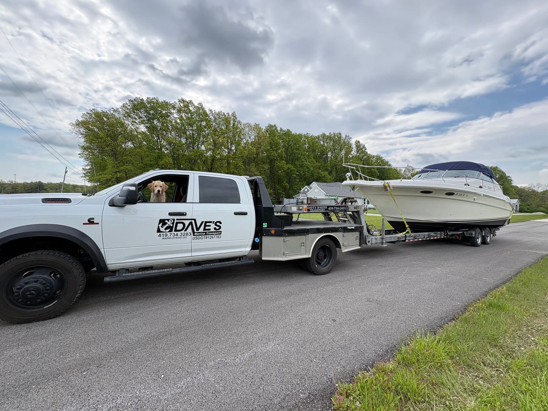Dave's Marine Transport truck hauling a cruiser