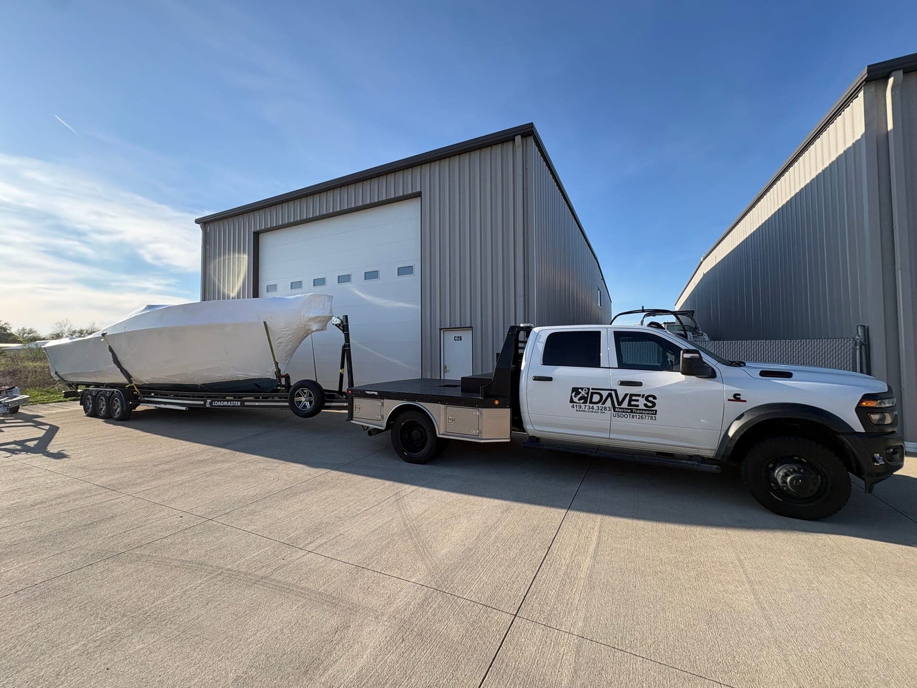 Shrink-wrapped boat arriving at the storage buildings