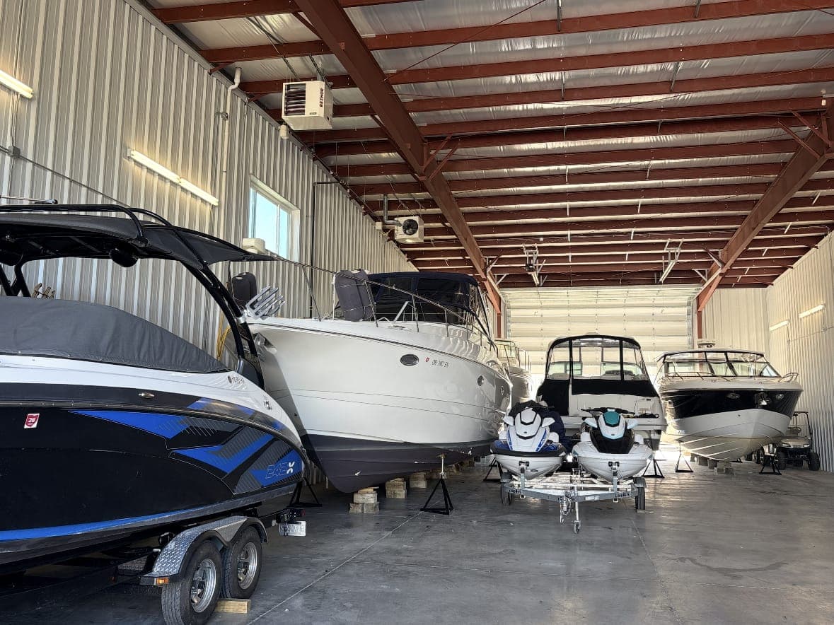 Boats and jet skis stored inside the heated Sure Shine storage bay
