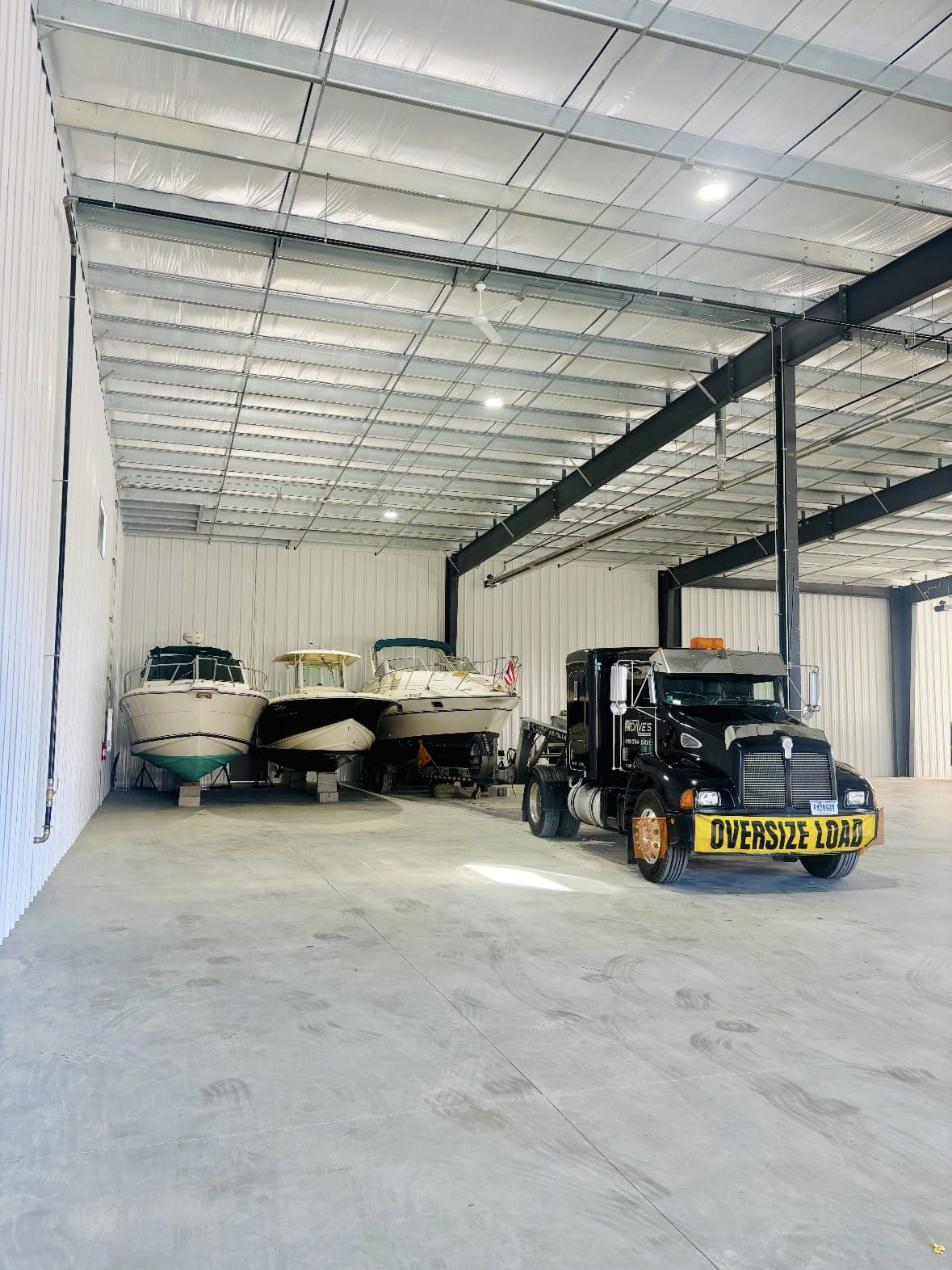 Storage bay with boats and the Dave's Marine Transport tractor