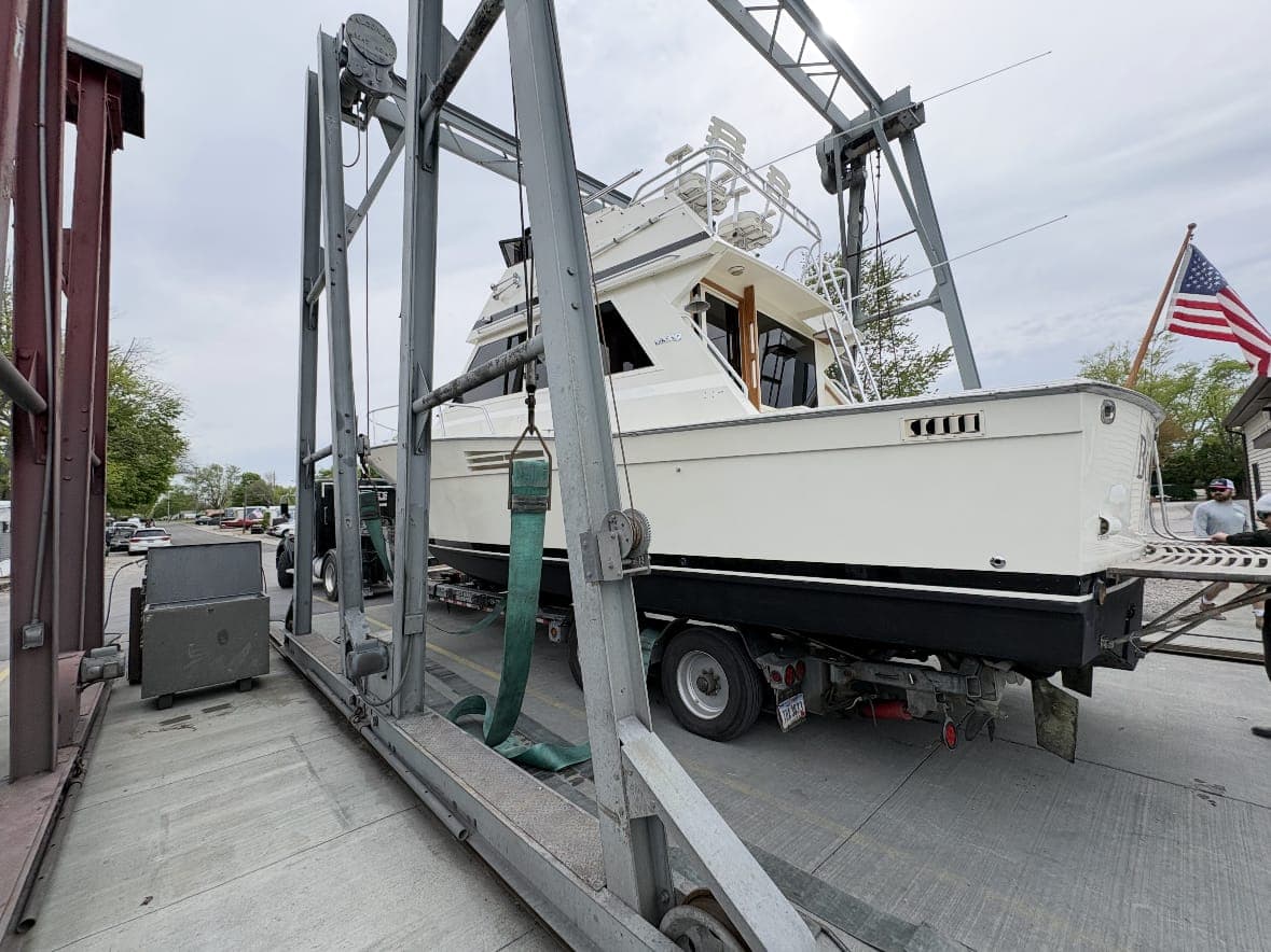 Boat on the hoist being loaded for storage